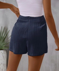 Rear view of navy high-waisted shorts featuring textured fabric and invisible back zipper