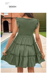 Detail of army green sleeveless dress featuring smocked back and ruffled tiered skirt hem