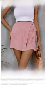 Detail of pink wrap skirt with tie-waist bow and vertical textured fabric design