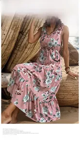 Detail of pink floral V-neck summer maxi dress with drawstring waist on beach