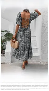 Detail of the cross-strap backless design on a floral summer dress with ruffles