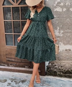 Close-up of dark green polka dot midi dress featuring V-neck buttons and drawstring waist