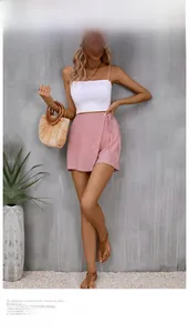 Chic women's summer outfit featuring white camisole and pink wrap tie skirt with texture