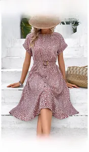 Detailed close-up of dark pink floral midi dress with a round neck and buckled waist belt