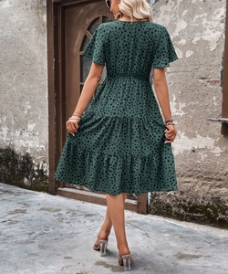 Back view of a summer dark green polka dot dress with layered ruffle hem and short sleeves