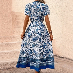 Bohemian white maxi dress with blue floral print and A-line silhouette for summer vacation