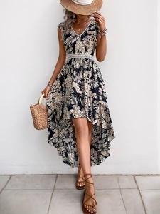 Detail of V-neck summer dress featuring palm leaf print and white lace trim accents