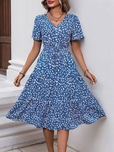 Detail of V-neck floral print dress with ruffle sleeves and tiered skirt texture