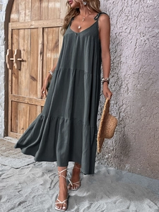 Detail of tiered olive green maxi dress featuring a V-neck and adjustable tie straps