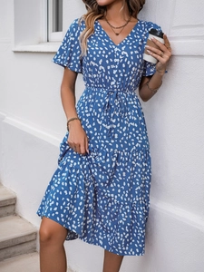 Detail of blue V-neck dress featuring white brushstroke print and ruffle hem sleeves