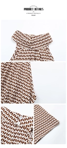 Detail of high-waisted halter dress showing geometric abstract print and back button closure