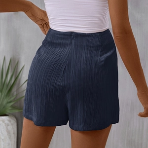 Women's navy high-waisted shorts with pleated texture and back zipper shown from behind