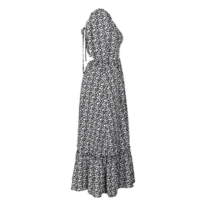 Detail view of floral summer dress showing backless ties and ruffled hemline textures