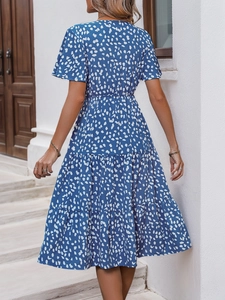 Rear view of a blue floral tiered midi dress with light ruffles for summer leisure
