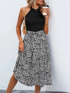 Detail of a sleeveless halter neck top and high-waisted leopard print midi skirt outfit