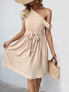 Detail of apricot textured summer dress with polka dot jacquard fabric and waist tie