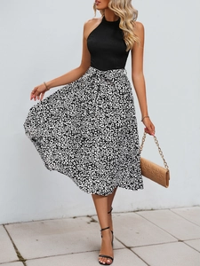 Detail of leopard print midi skirt with waist belt and black halter neck sleeveless top