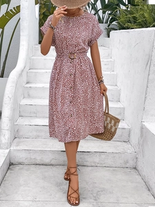 Women's summer floral dress in terracotta with belt and buttons on a sunny terrace
