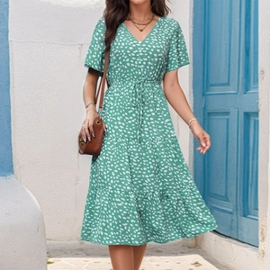 Detail of green floral V-neck dress with ruffle sleeves and tiered skirt for summer