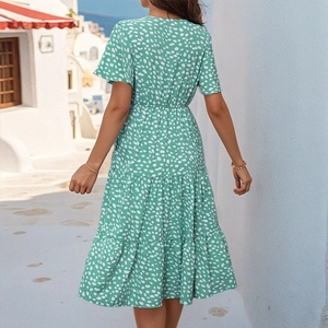 Rear view of green floral dress featuring tiered layers and bohemian style back detail