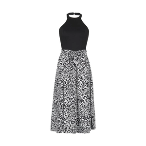Close-up of halter neck dress featuring black bodice and leopard print skirt with waist tie