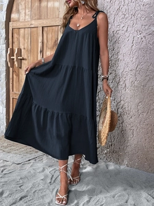 Detailed view of dark navy tiered maxi dress with pleated texture and adjustable straps