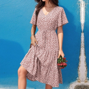 Detail of V-neck floral summer dress featuring drawstring waist and tiered ruffle hem