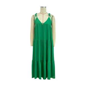 Detail view of the green tiered maxi dress with thin straps and layered pleated fabric