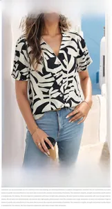 Detailed view of women's V-neck blouse with palm leaf print and front button design