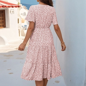 Detail of summer floral mini dress featuring a V-neck, ruffle sleeves and tiered skirt layering