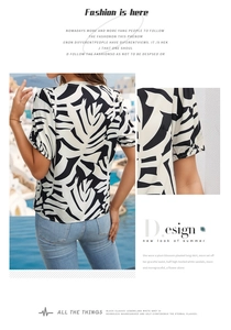 Detail of short puff sleeves on a black and white leaf print summer v-neck blouse