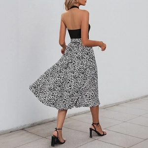 Modern halter backless top paired with leopard print midi skirt in high-quality outdoor shot