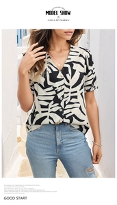 Detail of V-neck short sleeve shirt with black and white leaf print and button design