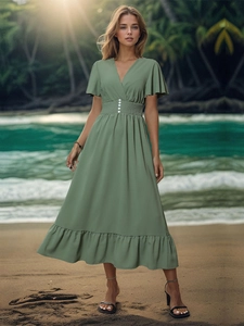 Detail of sage green V-neck dress featuring flutter sleeves and white button waist detail