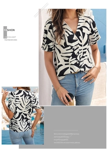 Detail of the V-neckline and black and white leaf print on this short sleeve shirt