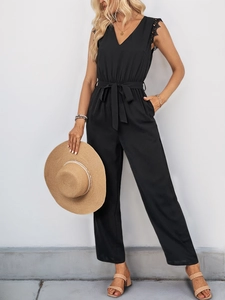 Close-up of elegant V-neck jumpsuit with lace trim and waist tie detailing