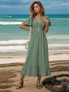 Detail of green V-neck midi dress with ruffled sleeves and elastic waist for summer vacation