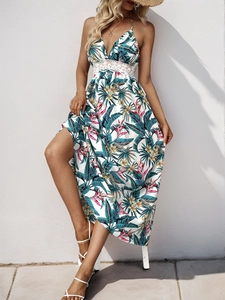 Detail of tropical floral print maxi dress with delicate white lace waist and side slit