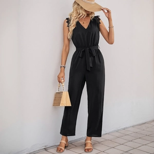 Chic black V-neck sleeveless jumpsuit with lace trim and waist tie in casual outdoor setting