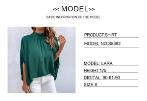 Detail view of dark green high-neck draped blouse with elegant pleated collar and batwing sleeves