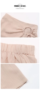 Detail of pink textured A-line shorts featuring elastic waistband and side lace-up design