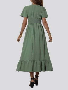 Elegant green smocked waist maxi dress with ruffle sleeves and tiered hemline