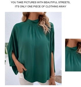 Detailed view of dark green mock neck blouse featuring elegant pleats and slit sleeves