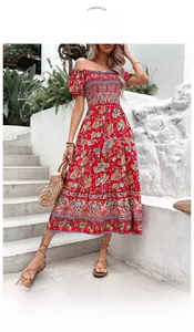 Detail of red boho maxi dress featuring smocked chest and floral off-shoulder design