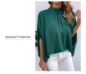 Close-up of elegant dark green mock neck blouse with asymmetric tie and batwing sleeves
