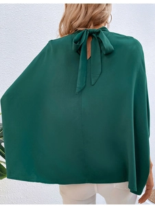 Back view of elegant dark green satin blouse with a sophisticated rear bow tie detail