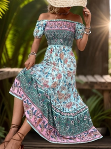 Detail of bohemian off-shoulder dress featuring tiered floral prints and puff sleeves