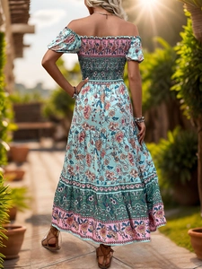 Detail of bohemian off-shoulder floral dress with elastic bodice and tiered skirt