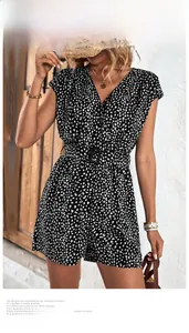 Detail showing deep V-neck leopard print romper with a black buckled waist belt
