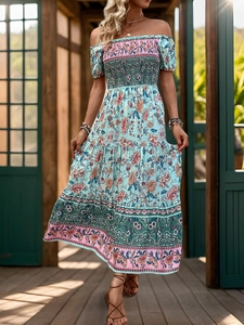 Detail of bohemian floral off-shoulder dress with elastic smocking and tiered skirt